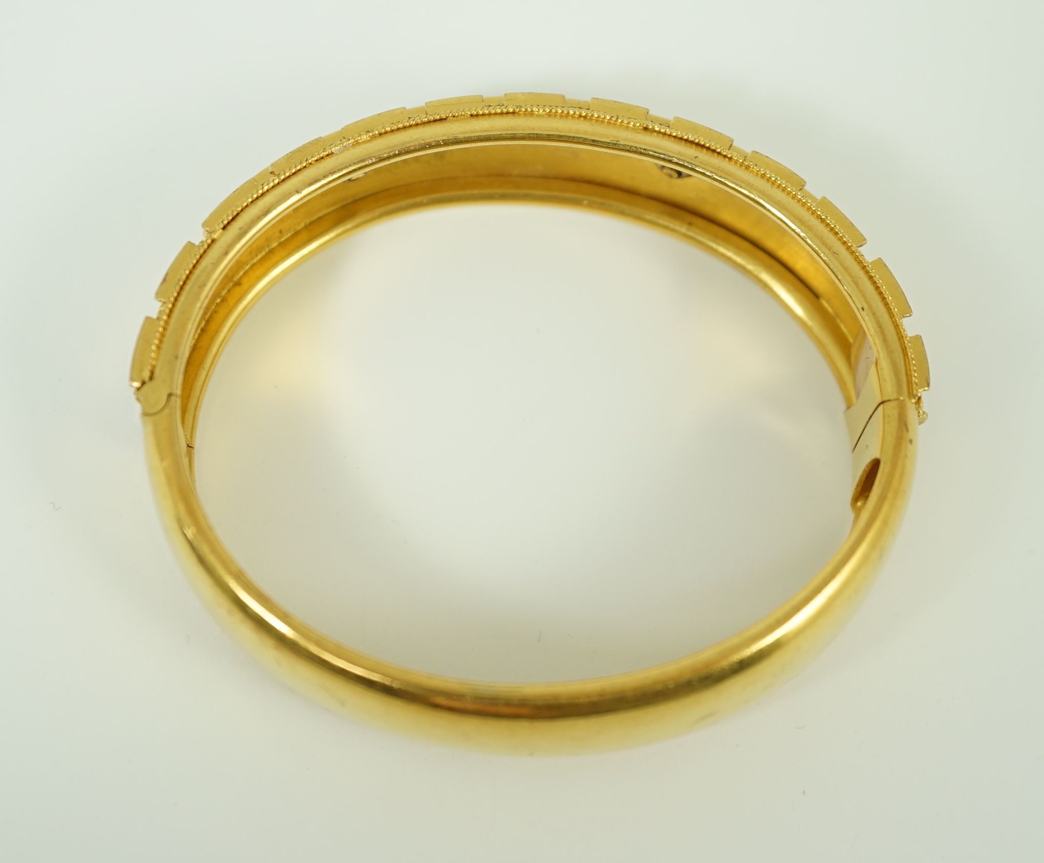 A late Victorian 15ct gold coral bead and seed pearl set part cannetile work hinged bangle
